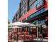 Outdoor patio area with red chairs and tables at Enzo Steakhouse & Bar, perfect for al fresco dining at 380 2Nd St, Fayetteville, GA 30214