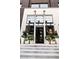 Native storefront with large windows, potted plants, and concrete steps leading to a black door at 380 2Nd St, Fayetteville, GA 30214