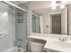 Bathroom featuring a vanity, large mirror with overhead lighting, and a shower with a glass door at 620 Peachtree Ne St # 1806, Atlanta, GA 30308