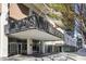 View of the front entrance of the Windsor Over Peachtree building on a sunny day at 620 Peachtree Ne St # 1806, Atlanta, GA 30308