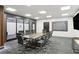 Modern conference room with a large table, comfortable chairs, and a wall-mounted television for professional meetings at 620 Peachtree Ne St # 1806, Atlanta, GA 30308