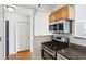 Compact kitchen with gas range and stainless steel appliances with view of hallway at 620 Peachtree Ne St # 1806, Atlanta, GA 30308