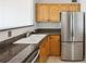 Well-lit kitchen featuring granite countertops and stainless steel refrigerator at 620 Peachtree Ne St # 1806, Atlanta, GA 30308