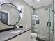 Bathroom featuring modern vanity, sleek lighting, and glass enclosed shower at 650 Jones Rd, Roswell, GA 30075