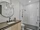 Modern bathroom featuring starburst lighting, a patterned shower, and sleek black fixtures at 650 Jones Rd, Roswell, GA 30075