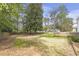 Sprawling green backyard enclosed by a wood fence and mature trees at 1631 Dresden Ne Dr, Brookhaven, GA 30319