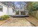 Exterior shot showcasing a brick paver patio leading to a wood deck and a covered area at 1631 Dresden Ne Dr, Brookhaven, GA 30319