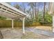 Covered backyard patio with a stained wood fence and a mix of wood and concrete flooring at 1631 Dresden Ne Dr, Brookhaven, GA 30319