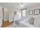 Well-lit bedroom with hardwood floors, artwork and a dresser at 1631 Dresden Ne Dr, Brookhaven, GA 30319