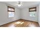 Empty bedroom with wood floors and two windows at 1631 Dresden Ne Dr, Brookhaven, GA 30319