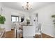 Cozy dining room with wood floors, a round table, and views into the living room and kitchen at 1631 Dresden Ne Dr, Brookhaven, GA 30319