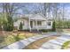 Beautifully landscaped home with a cozy front porch, white picket fence, and a welcoming driveway at 1631 Dresden Ne Dr, Brookhaven, GA 30319