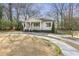 Charming home with a covered porch, neat landscaping, and a curved driveway at 1631 Dresden Ne Dr, Brookhaven, GA 30319