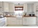 Bright kitchen boasts white cabinets, butcher block countertops and white appliances at 1631 Dresden Ne Dr, Brookhaven, GA 30319
