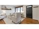 Bright living room featuring hardwood floors, a modern sofa, and large windows at 1631 Dresden Ne Dr, Brookhaven, GA 30319