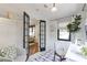 Bright home office with white walls, black framed window, and glass paneled French doors at 1631 Dresden Ne Dr, Brookhaven, GA 30319