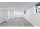 This finished basement offers new gray floors, fresh paint, and natural light from two windows at 175 Jayne Ellen Way, Alpharetta, GA 30009