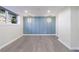 Finished basement with stylish blue accent wall and modern lighting at 175 Jayne Ellen Way, Alpharetta, GA 30009
