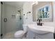Modern bathroom with tiled shower featuring glass door, sleek fixtures, and stylish vanity with storage at 175 Jayne Ellen Way, Alpharetta, GA 30009