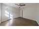 This bedroom has fresh paint, hardwood floors, a modern ceiling fan, and two access doors at 175 Jayne Ellen Way, Alpharetta, GA 30009