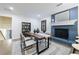 Open dining space featuring a brick fireplace, wood table, neutral colors, and hardwood floors at 175 Jayne Ellen Way, Alpharetta, GA 30009