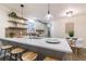Updated kitchen featuring island seating, brick backsplash, quartz countertops, and stainless appliances at 175 Jayne Ellen Way, Alpharetta, GA 30009