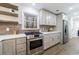 Modern kitchen featuring stainless steel appliances, bright white cabinets, and open shelving at 175 Jayne Ellen Way, Alpharetta, GA 30009