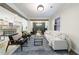Open-concept living area with hardwood floors, neutral decor, wood beams, and an abundance of natural light at 175 Jayne Ellen Way, Alpharetta, GA 30009