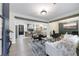Bright, open-concept living room boasting hardwood floors, stylish furniture, and decorative wood beams at 175 Jayne Ellen Way, Alpharetta, GA 30009