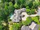 Aerial view of estate featuring a swimming pool, manicured landscaping, and circular driveway at 510 Covington Cv, Alpharetta, GA 30022