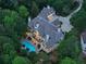 Aerial shot of a beautiful home with a private backyard oasis, complete with a pool and multiple outdoor living areas at 510 Covington Cv, Alpharetta, GA 30022