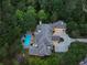 Aerial view of a luxurious home with meticulously maintained landscaping and a private backyard featuring a sparkling pool and spa at 510 Covington Cv, Alpharetta, GA 30022