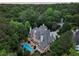Aerial view of an impressive home surrounded by lush greenery, highlighting the private setting and ample outdoor space at 510 Covington Cv, Alpharetta, GA 30022