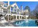 This home's backyard features a pool, balcony, patio, manicured lawn and elegant architecture at 510 Covington Cv, Alpharetta, GA 30022