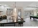 Modern bar area featuring sleek countertops, pendant lighting, and views of the recreation room at 510 Covington Cv, Alpharetta, GA 30022