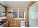 Bathroom with a stone tile wall, vessel sink and an enclosed shower at 510 Covington Cv, Alpharetta, GA 30022
