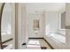 Clean, bright bathroom with white tile, a soaking tub and lots of natural light at 510 Covington Cv, Alpharetta, GA 30022