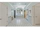 Large primary bathroom with tiled floors, tub under an arched window, and double vanity at 510 Covington Cv, Alpharetta, GA 30022