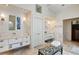 Bright primary bathroom with dual vanities, walk-in shower, luxurious bench, and spa-like atmosphere at 510 Covington Cv, Alpharetta, GA 30022