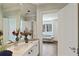 Bathroom featuring a single vanity and doorway that leads into a bright living room space at 510 Covington Cv, Alpharetta, GA 30022
