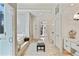 Bright bathroom showcasing the shower with a window, soaking tub, zebra bench and white cabinetry at 510 Covington Cv, Alpharetta, GA 30022