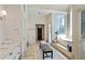 Bright primary bathroom offers dual vanities, a soaking tub with natural light, and elegant finishes throughout at 510 Covington Cv, Alpharetta, GA 30022