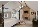 Bedroom with a stone fireplace, chandelier and hardwood floors at 510 Covington Cv, Alpharetta, GA 30022