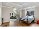 Bedroom with a four poster bed adjacent to an office with custom built in shelves at 510 Covington Cv, Alpharetta, GA 30022