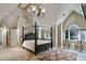 Bedroom features a four-poster bed and a vaulted ceiling, enhanced by natural light at 510 Covington Cv, Alpharetta, GA 30022