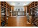Spacious walk-in closet with custom shelving, cabinets, central island and natural light at 510 Covington Cv, Alpharetta, GA 30022