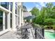 Relaxing patio with black metal furniture overlooking the swimming pool and lush greenery at 510 Covington Cv, Alpharetta, GA 30022