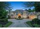 Stately home boasts a circular driveway, three-car garage, and meticulously maintained landscaping at 510 Covington Cv, Alpharetta, GA 30022