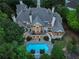 Aerial image of a gorgeous home showcasing its expansive rear facade, outdoor living spaces, and stunning pool area at 510 Covington Cv, Alpharetta, GA 30022
