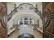 Grand foyer with marble floors, curved staircase, wrought iron railings and soaring ceilings at 510 Covington Cv, Alpharetta, GA 30022